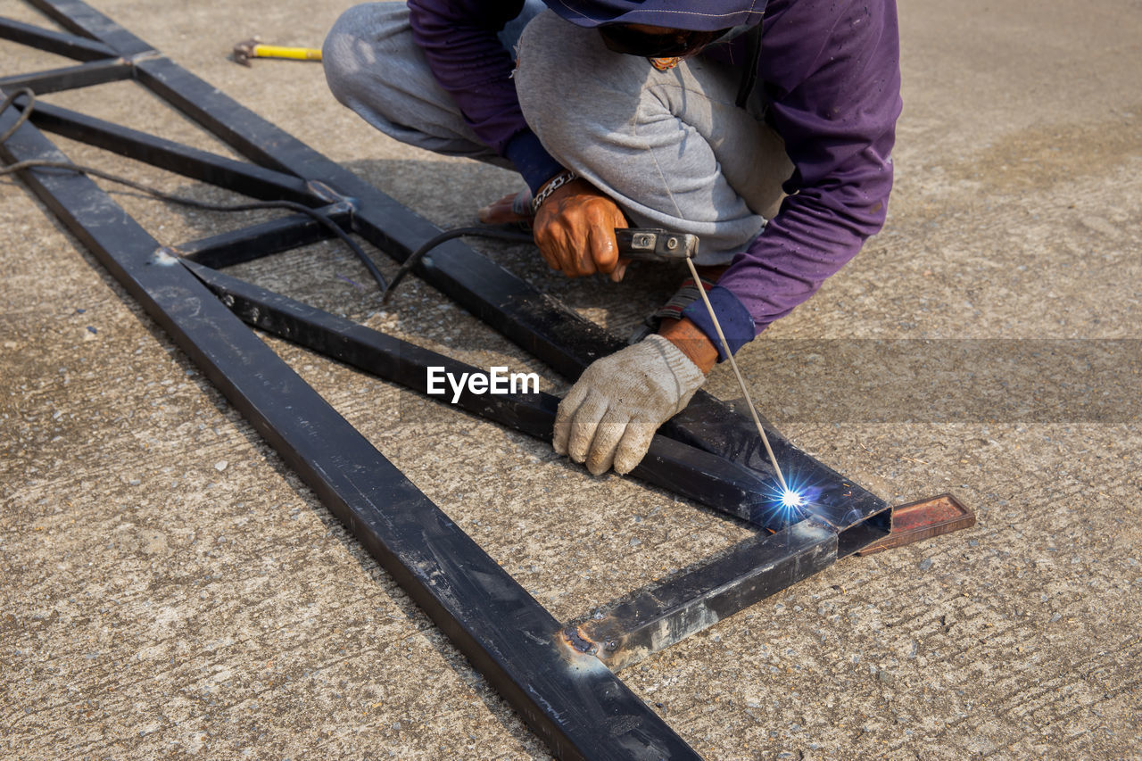 LOW SECTION OF MAN WORKING WITH METAL