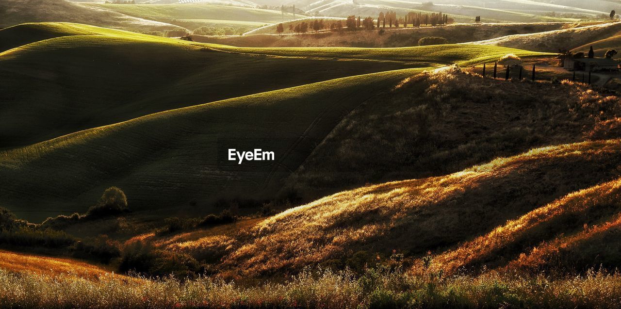 Scenic view of field against cloudy sky