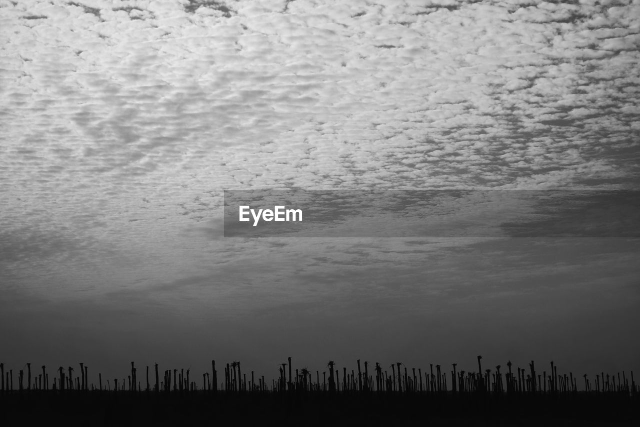 View of cityscape against cloudy sky