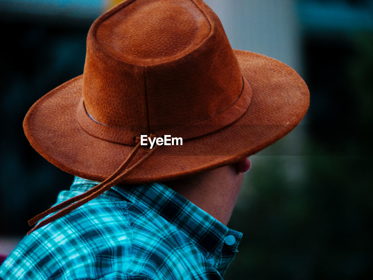 Rear view of person wearing hat standing outdoors