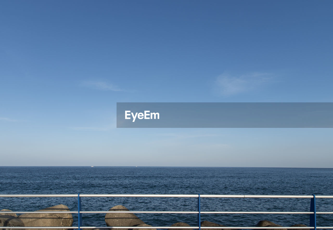 Scenic view of sea against blue sky