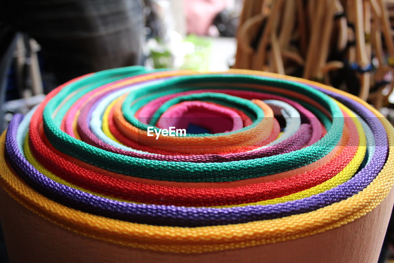 Close-up of rolled colorful fabrics at market