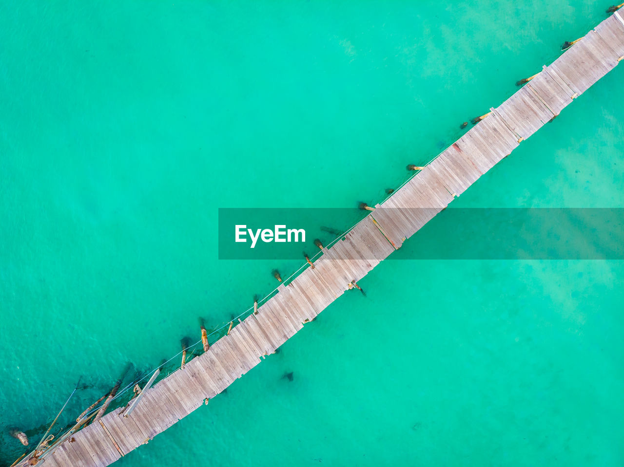 HIGH ANGLE VIEW OF SWIMMING POOL IN BLUE SEA