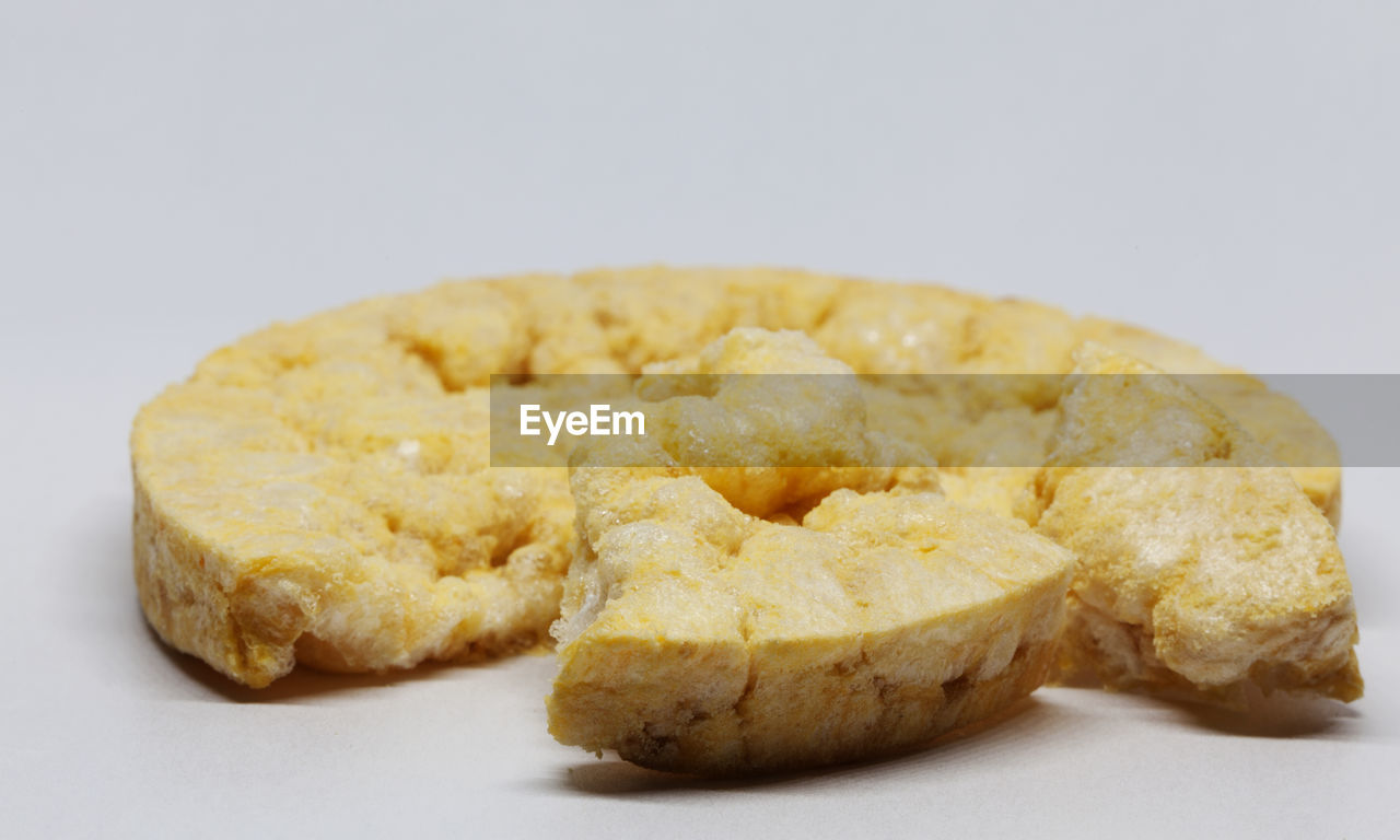 CLOSE-UP OF BREAD ON WHITE BACKGROUND