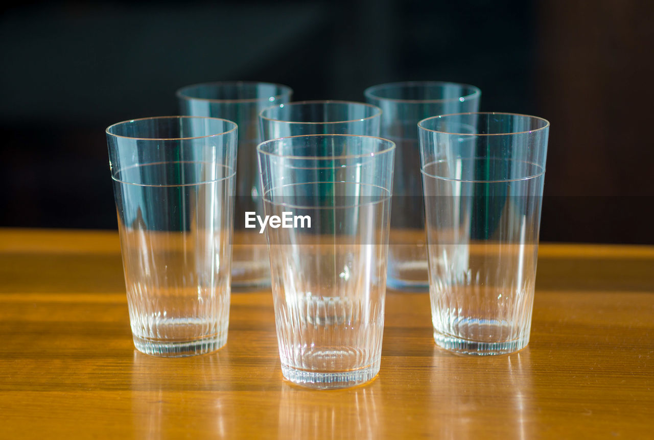 Close-up of glasses arranged on table