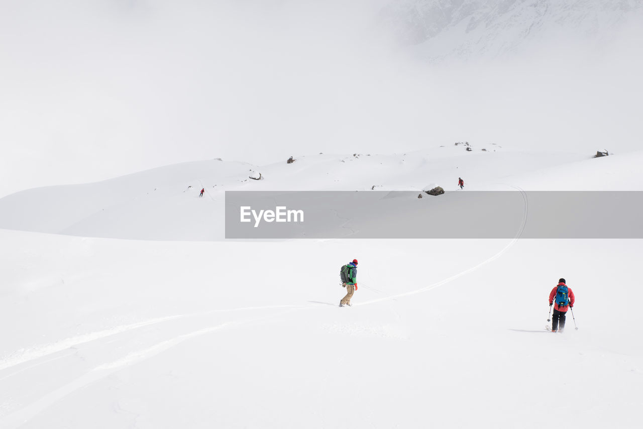 People skiing on snowcapped mountain