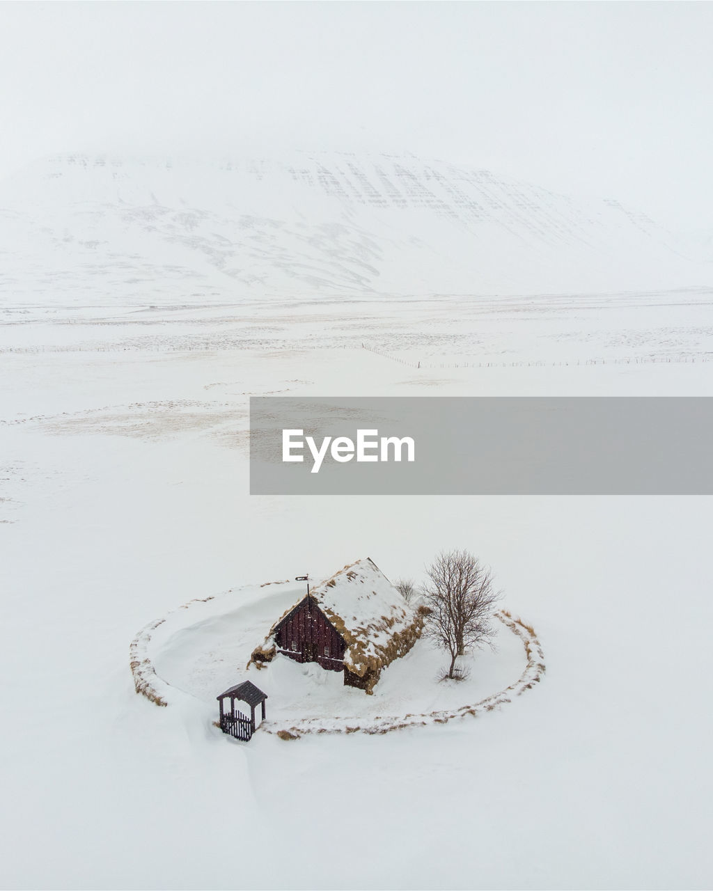 High angle view of snow covered land and turf church