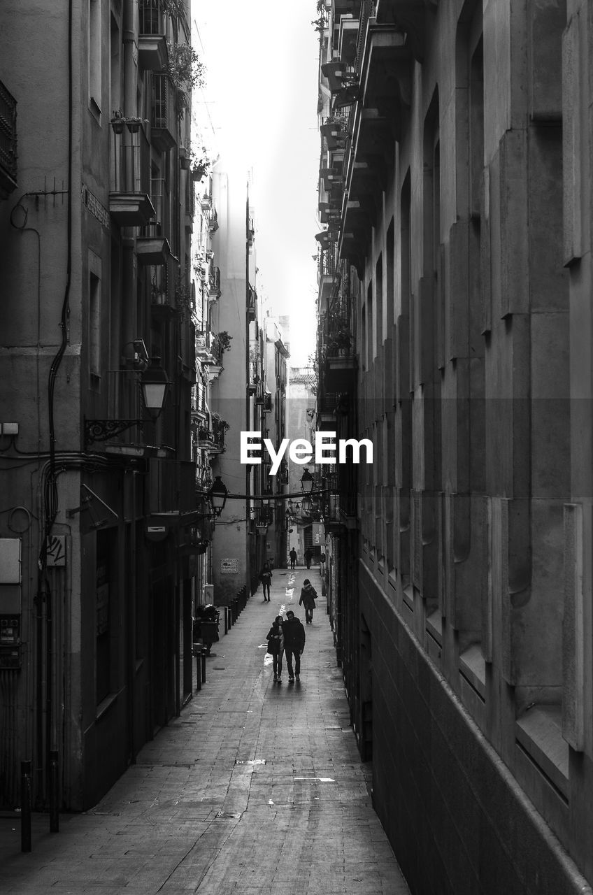 MAN ON COBBLESTONE STREET IN CITY