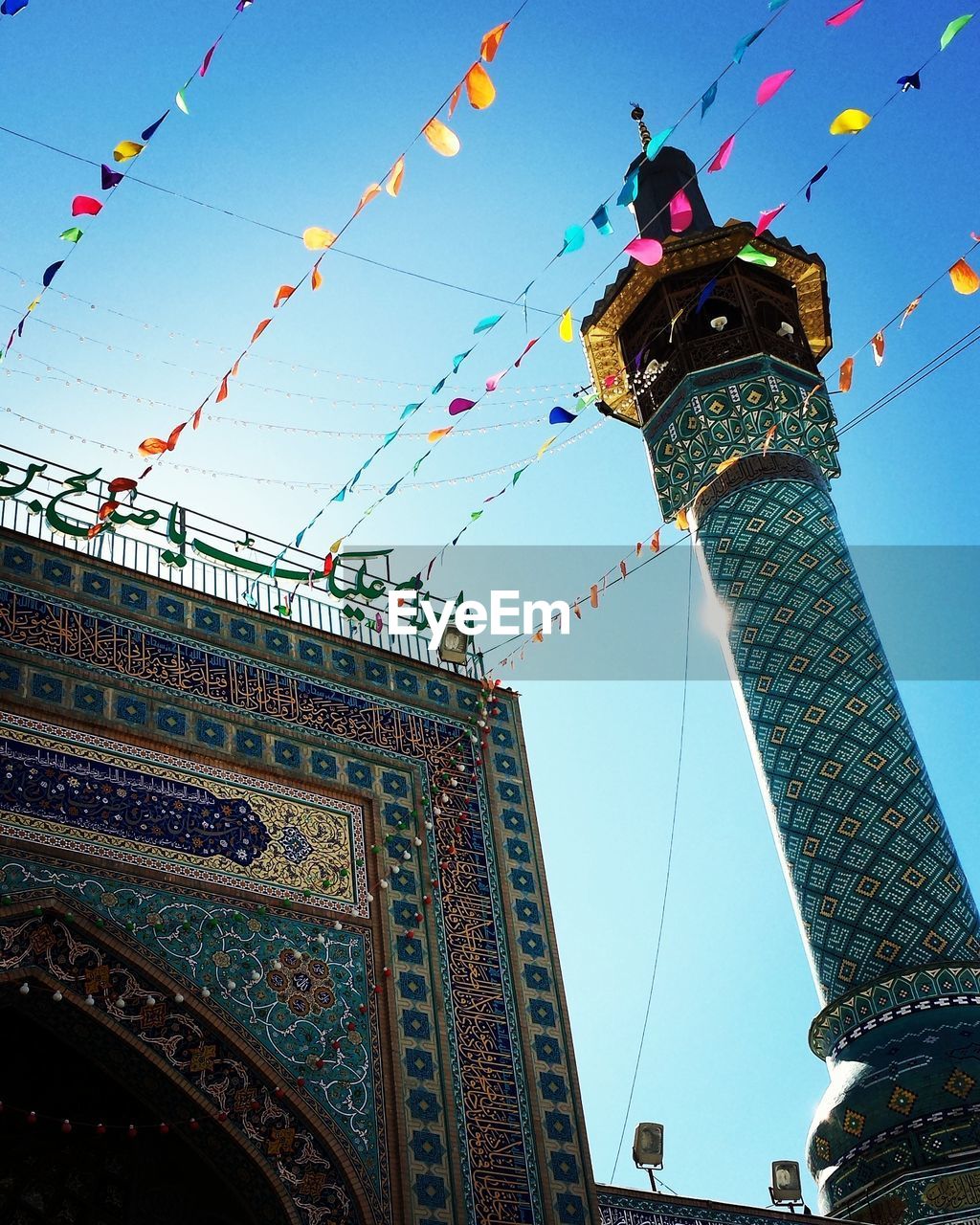 LOW ANGLE VIEW OF EIFFEL TOWER AGAINST BLUE SKY