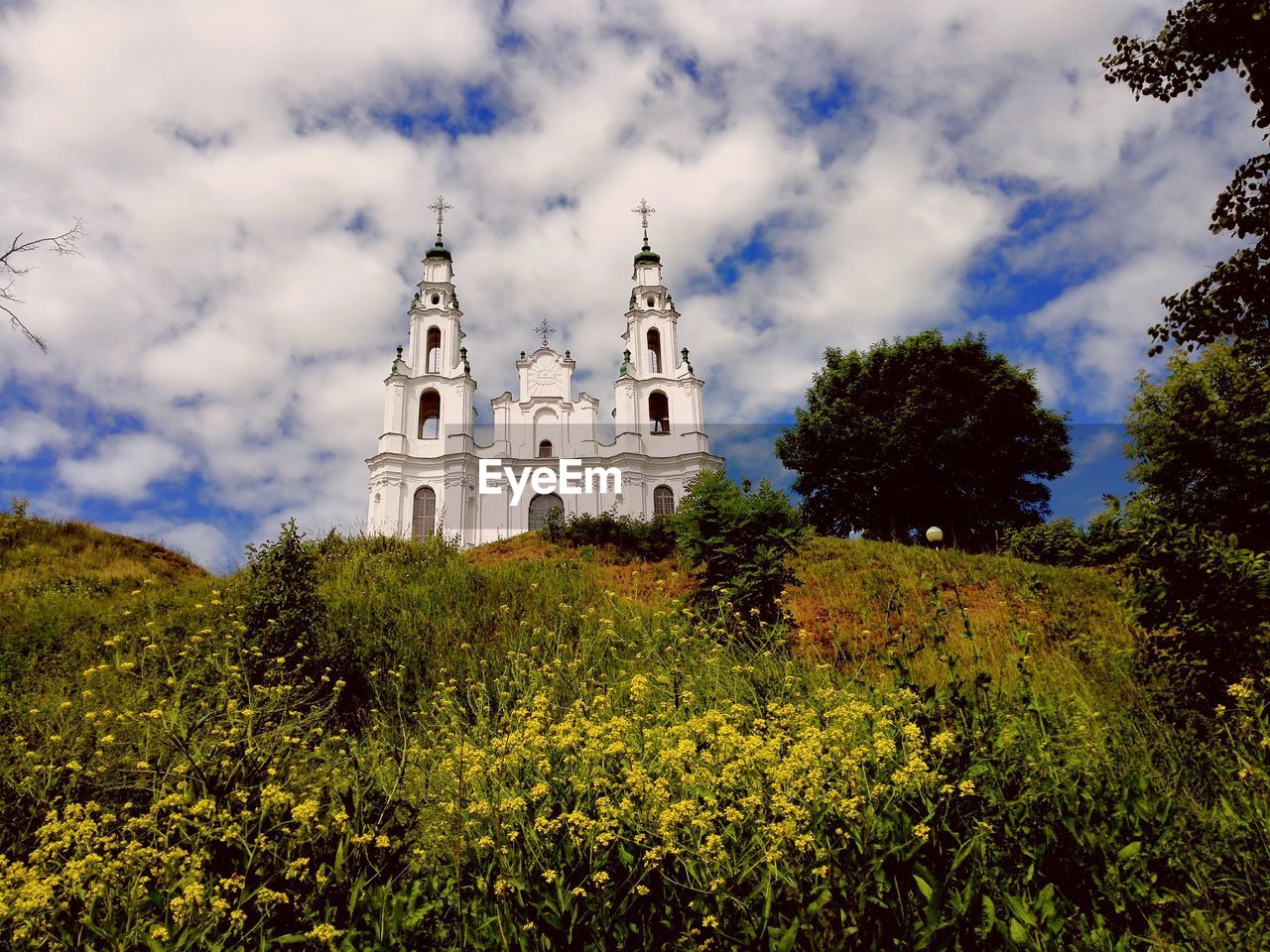 Low angle view of church against cloudy sky