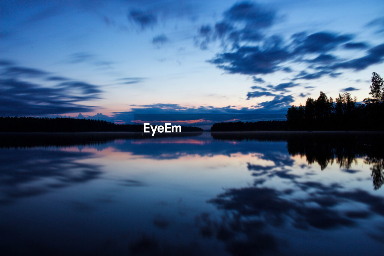 Reflection of clouds in lake at sunset