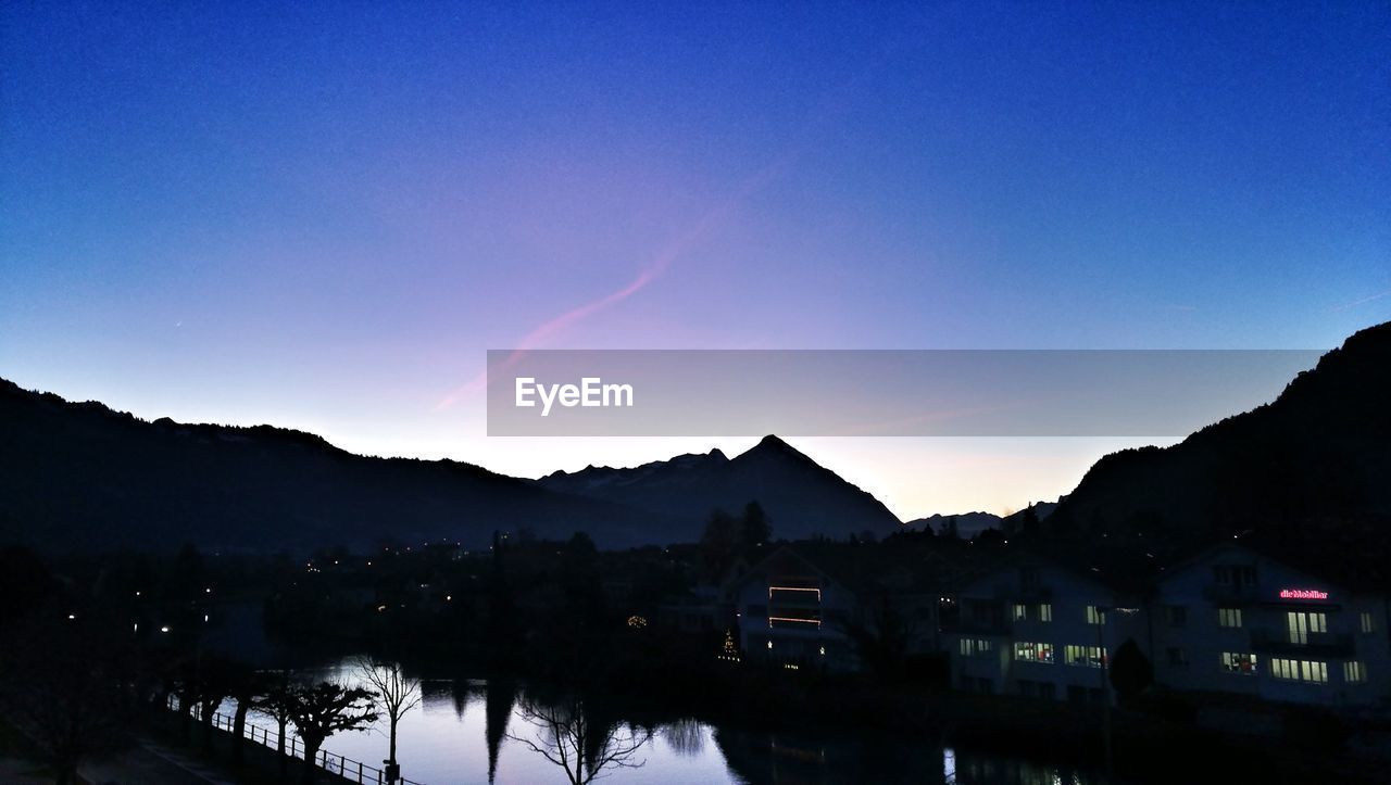 PANORAMIC VIEW OF MOUNTAINS AGAINST SKY AT SUNSET