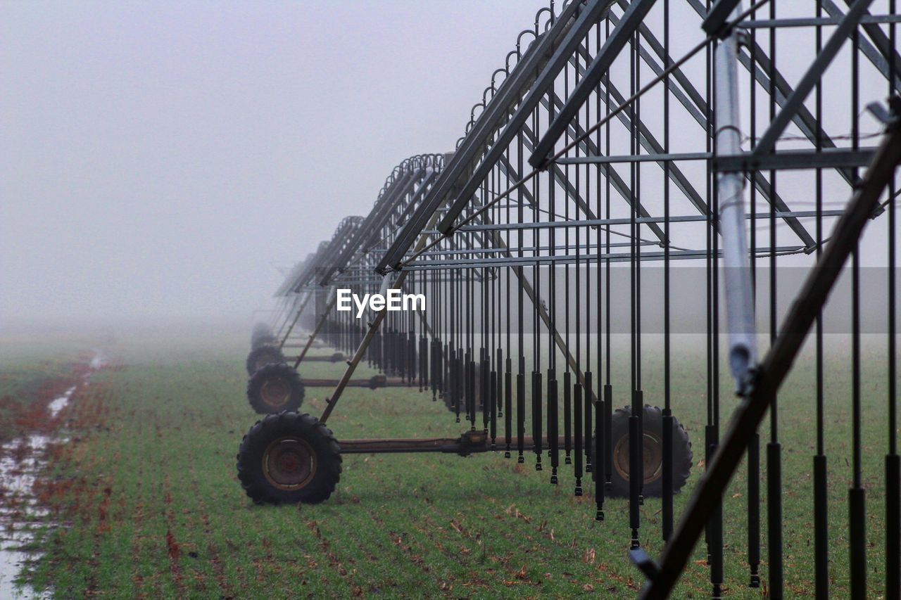 Agricultural equipment on land during foggy weather