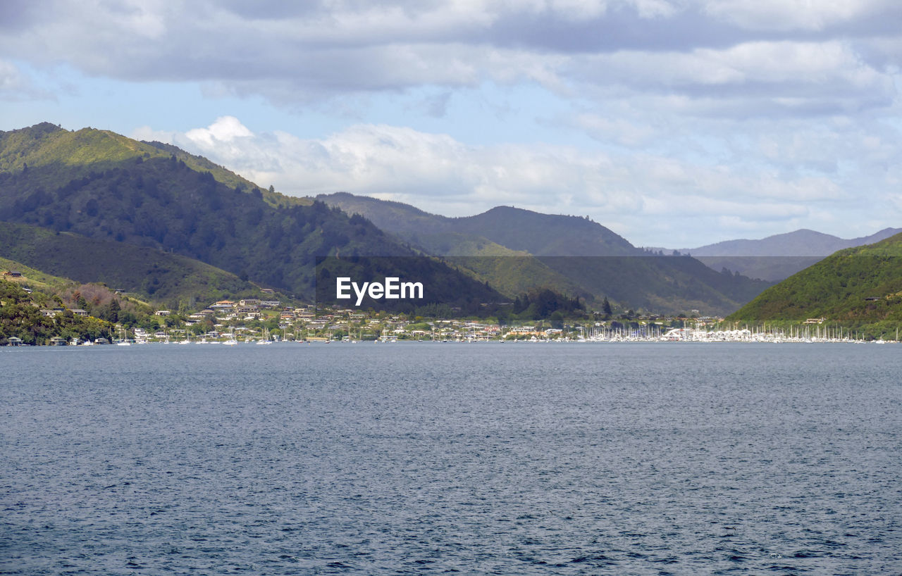 SCENIC VIEW OF SEA AND MOUNTAIN AGAINST SKY