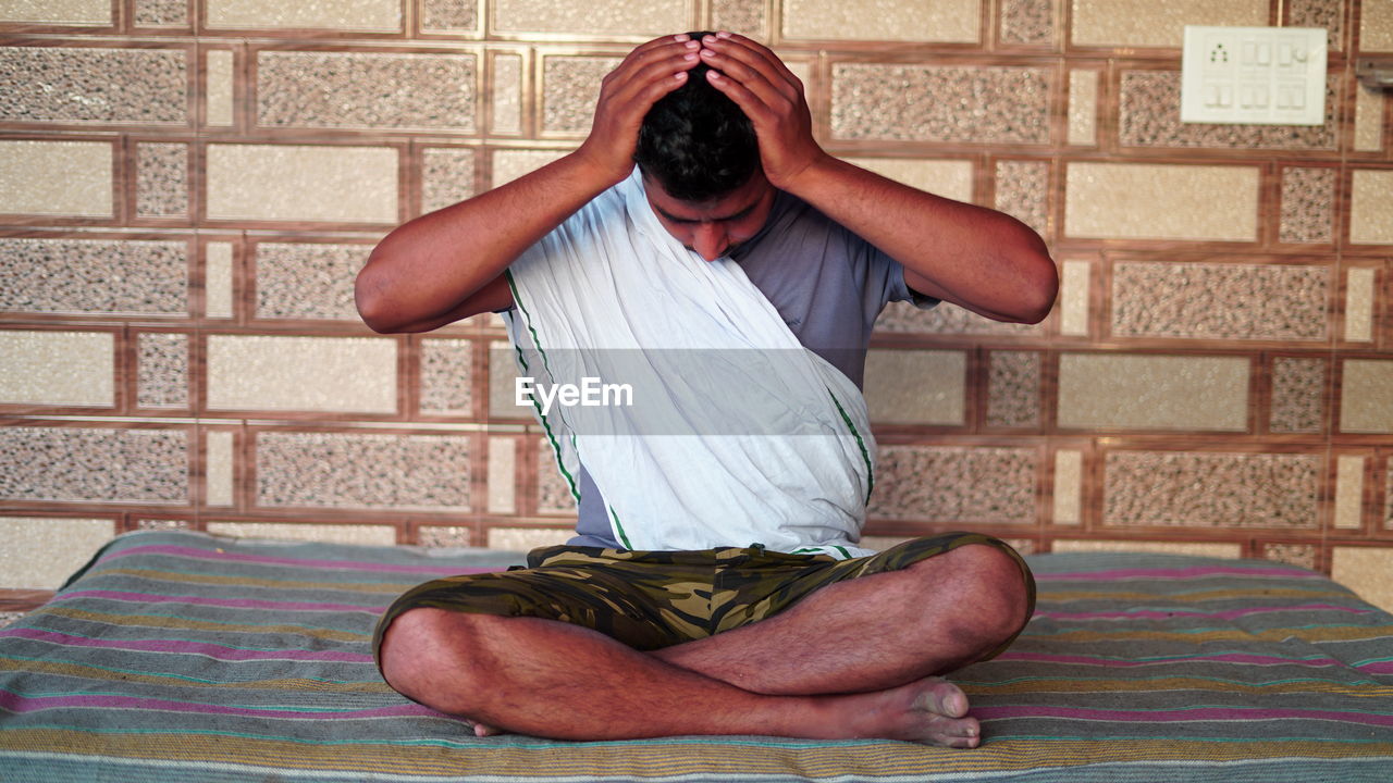 MAN SITTING ON WALL