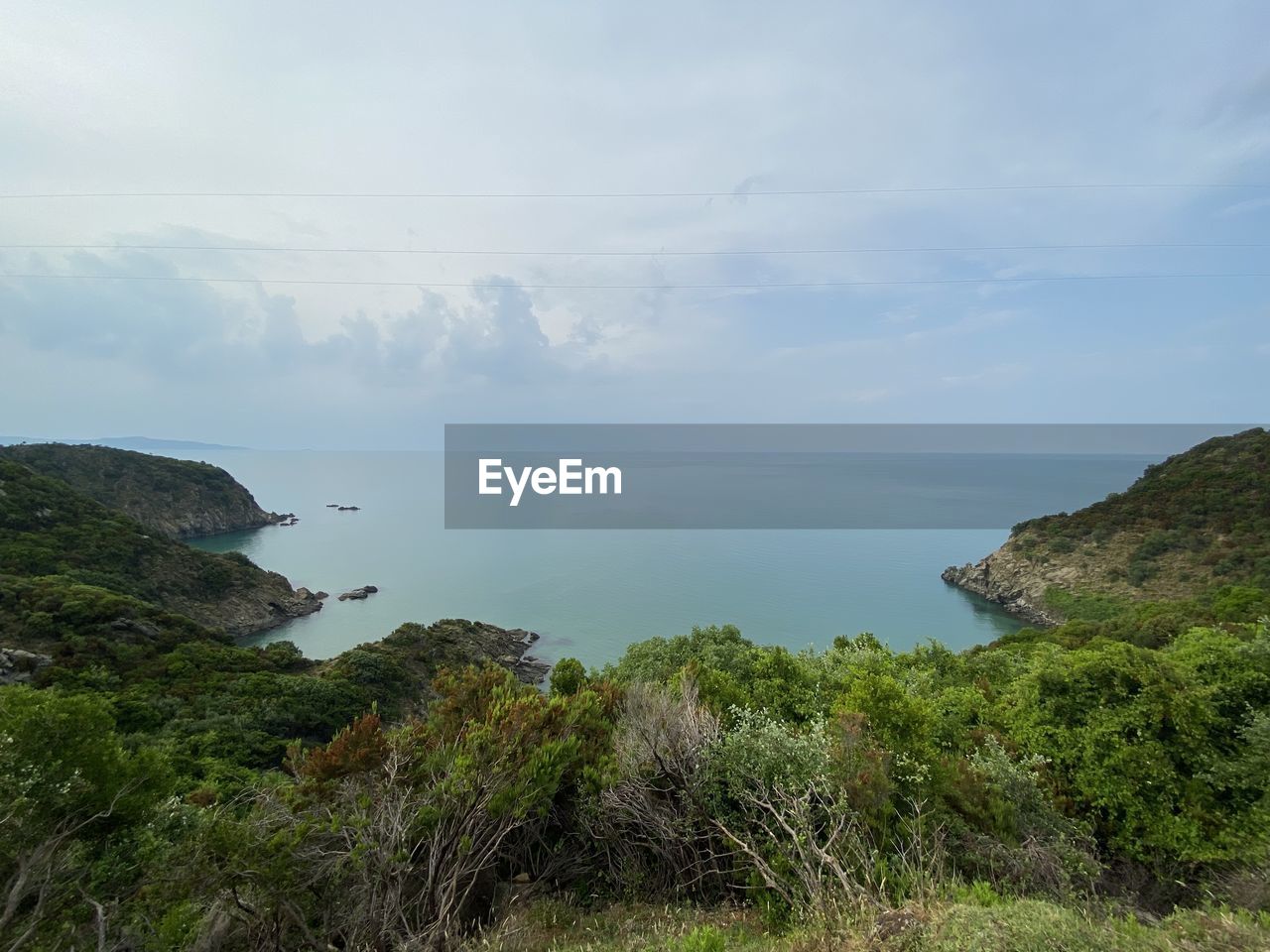 water, beauty in nature, scenics - nature, coast, sky, sea, tranquility, plant, nature, tranquil scene, hill, land, cloud, cliff, body of water, shore, no people, environment, bay, beach, non-urban scene, landscape, day, horizon over water, ocean, idyllic, rock, outdoors, tree, terrain, grass, horizon, wilderness, green, highland, travel, travel destinations, growth, reservoir, coastline