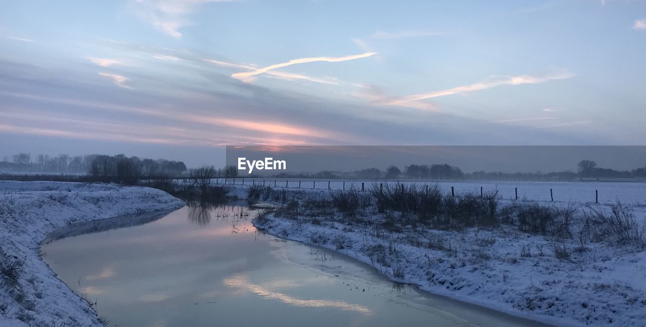 Scenic view of lake against sky during sunset