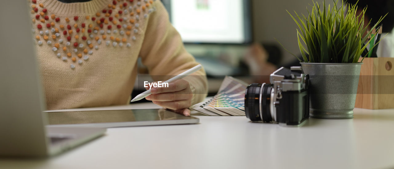 Midsection of woman working at desk