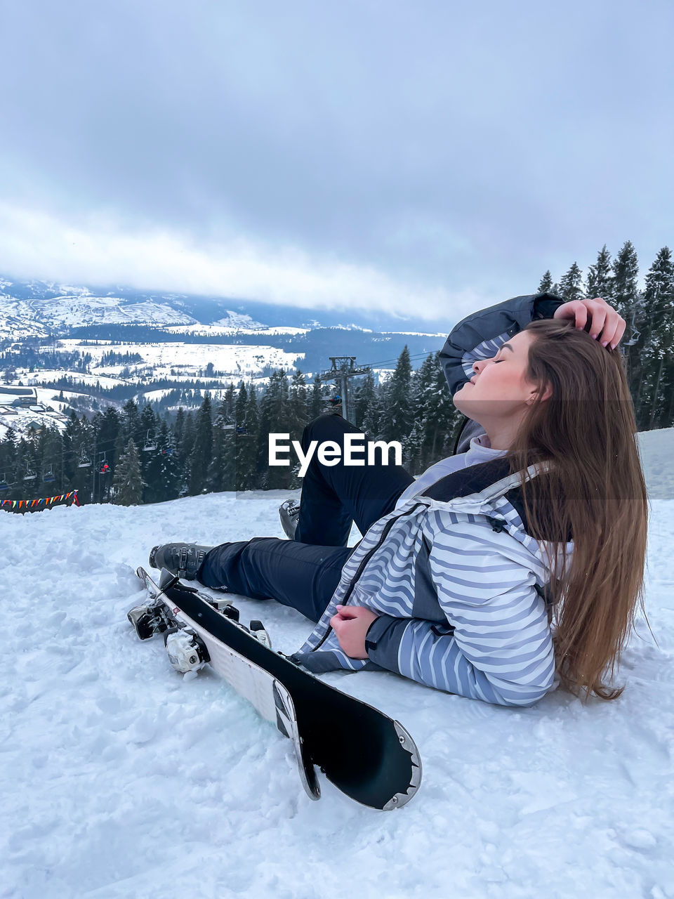 Shot of a skier woman sitting on the ski slope resting relaxing extreme recreation active lifestyle