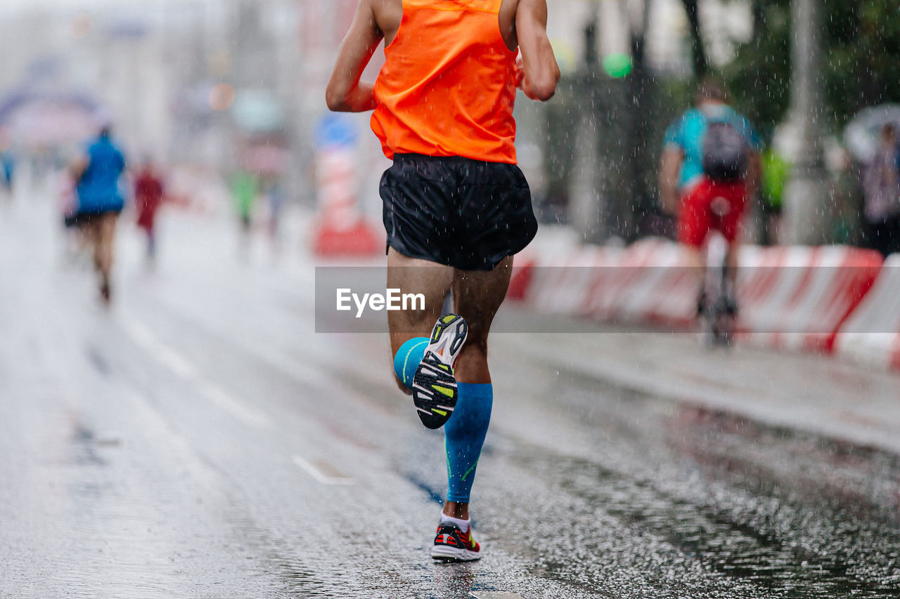 low section of woman jogging on road