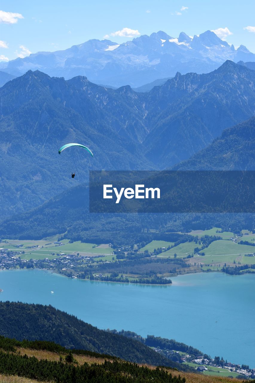 Scenic view of mountains against sky with paraglider