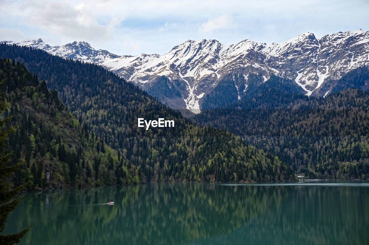 Scenic view of lake and mountains against sky