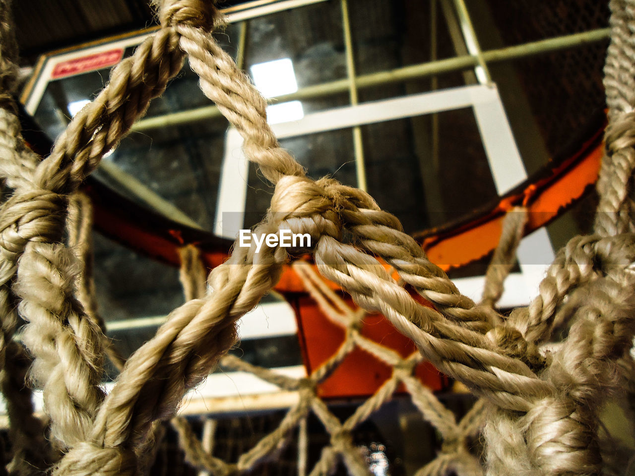 CLOSE-UP OF ROPES TIED ON METAL