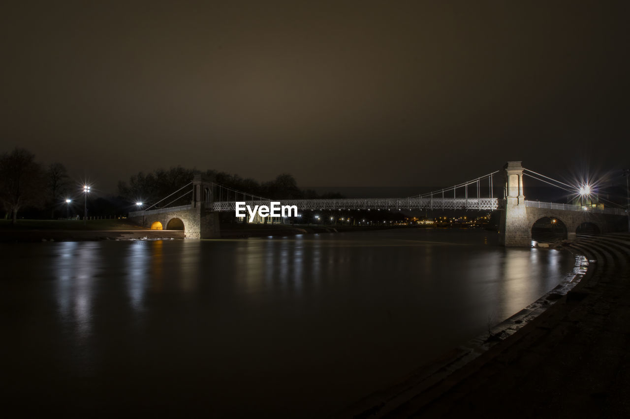 night, architecture, bridge, illuminated, built structure, water, reflection, darkness, light, transportation, dusk, travel destinations, city, sky, evening, nature, river, building exterior, no people, suspension bridge, travel, tourism, copy space, outdoors, long exposure, cityscape, street