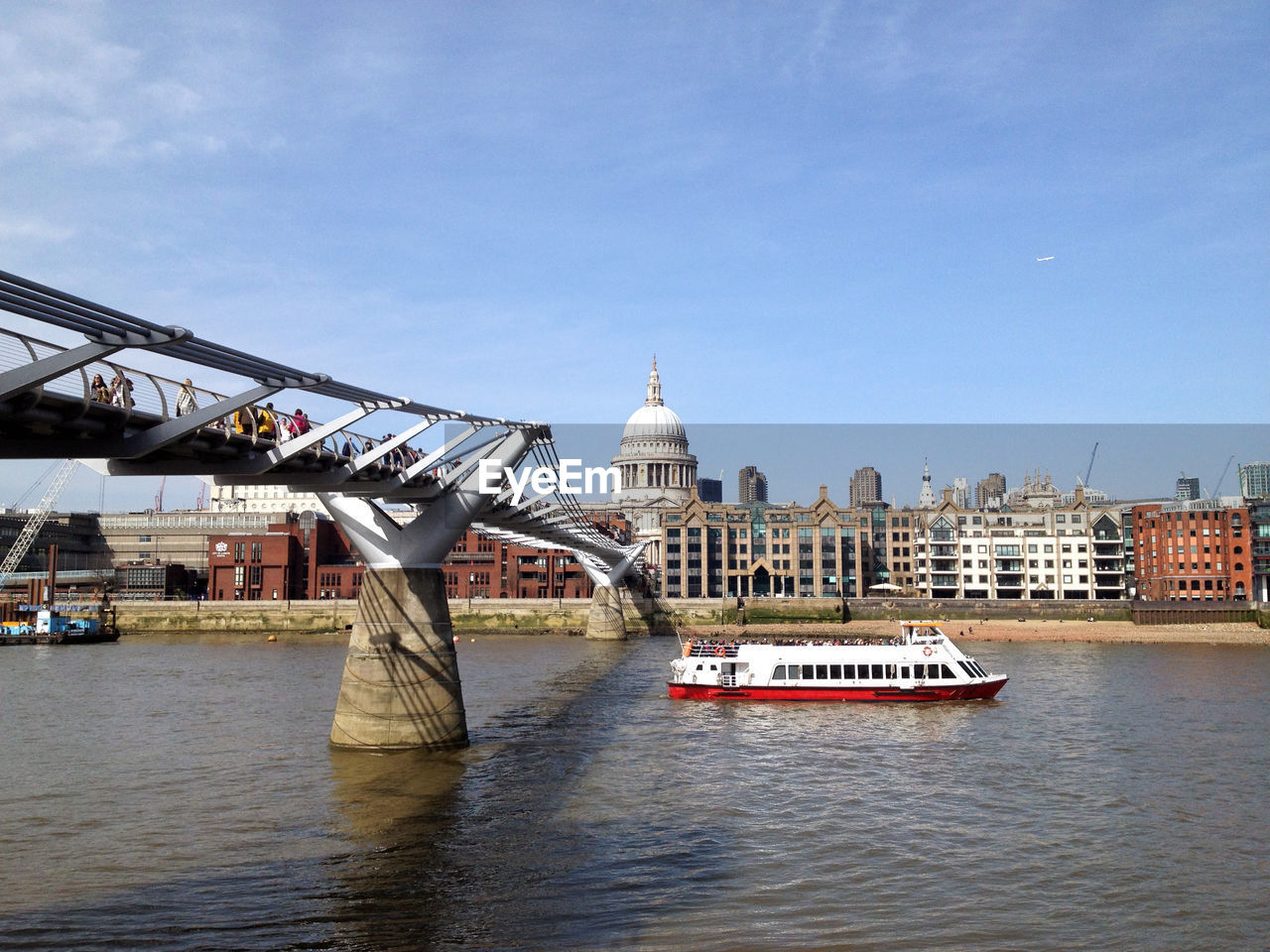 Bridge over river against built structures