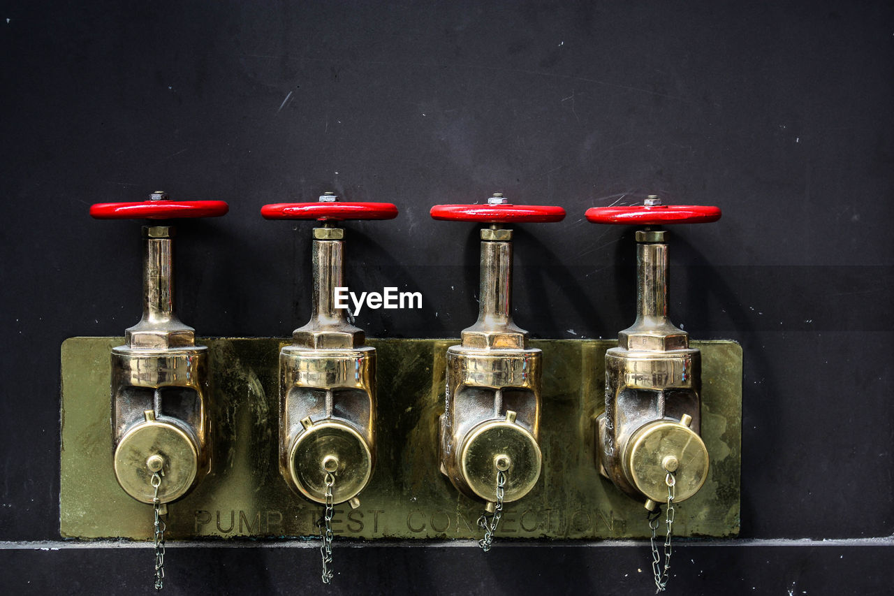 Machine valves against wall