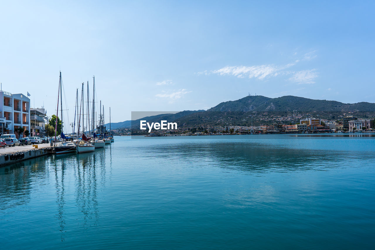 water, sky, sea, architecture, nautical vessel, transportation, nature, mountain, city, travel destinations, bay, building exterior, travel, mode of transportation, harbor, built structure, vehicle, ship, scenics - nature, building, land, body of water, blue, no people, beauty in nature, tranquility, marina, waterfront, tourism, day, tranquil scene, coast, reflection, boat, outdoors, beach, landscape, dock, trip, vacation, holiday, sailboat, cloud, pier, idyllic, moored, clear sky, environment, yacht, cityscape, residential district, ocean, horizon, house, town