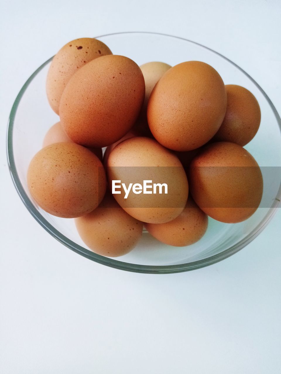 HIGH ANGLE VIEW OF EGGS IN CONTAINER ON TABLE