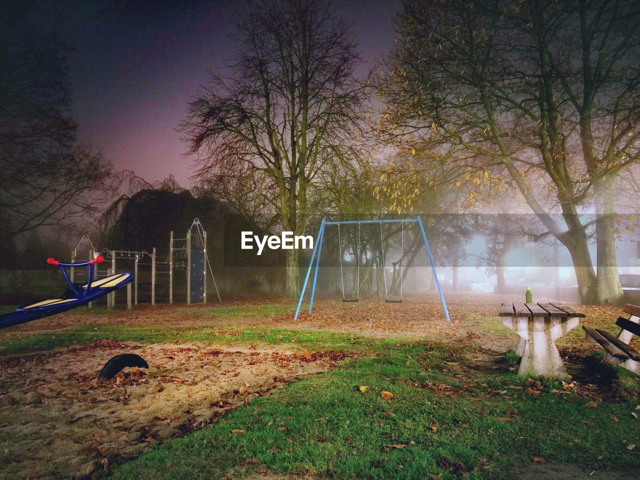 Swings at playground against sky