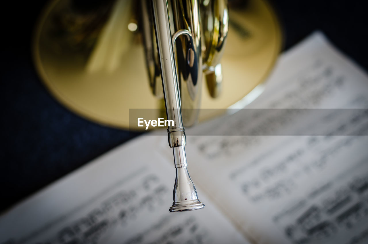 Close-up of musical instrument with sheet music on table