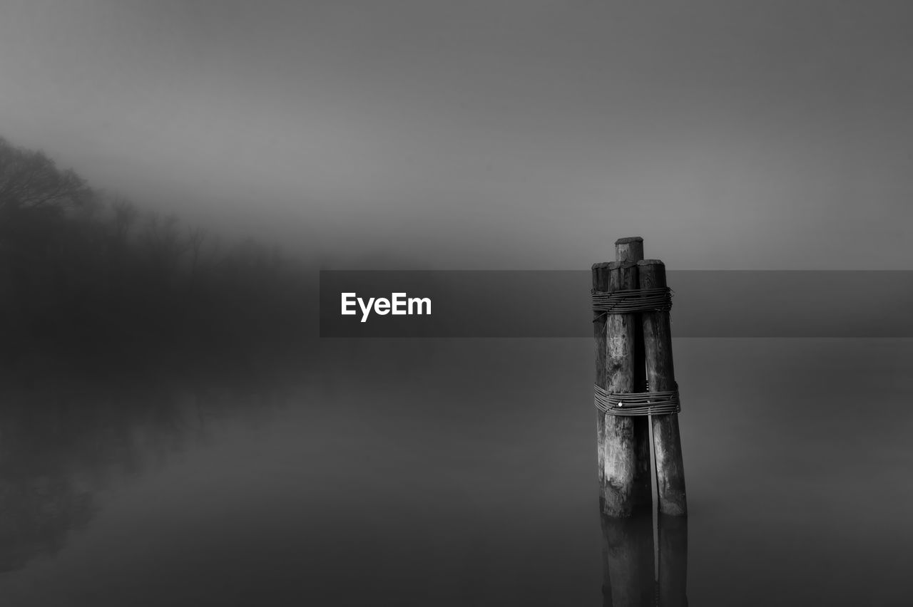 fog, black and white, monochrome, darkness, monochrome photography, no people, water, cloud, mist, nature, tranquility, sky, wood, reflection, scenics - nature, tranquil scene, lake, beauty in nature, outdoors, environment, day