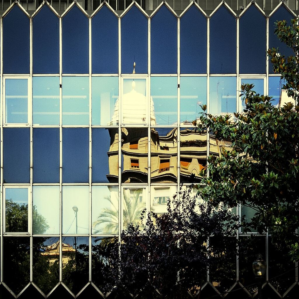 Reflection of building in glass wall