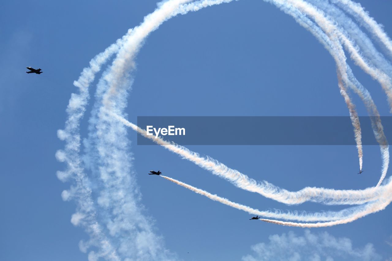 Low angle view of airshow in sky