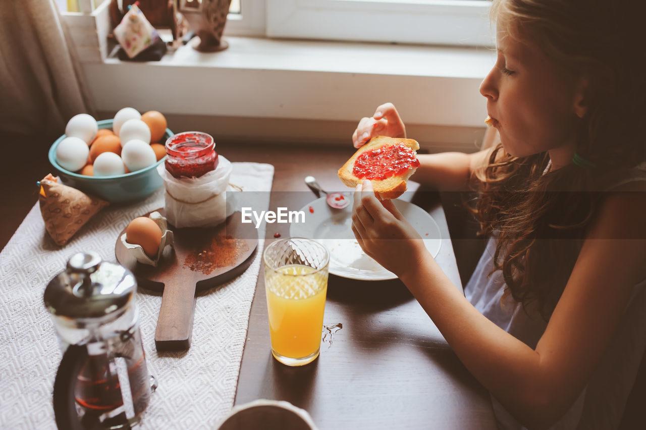 Girl having breakfast at home