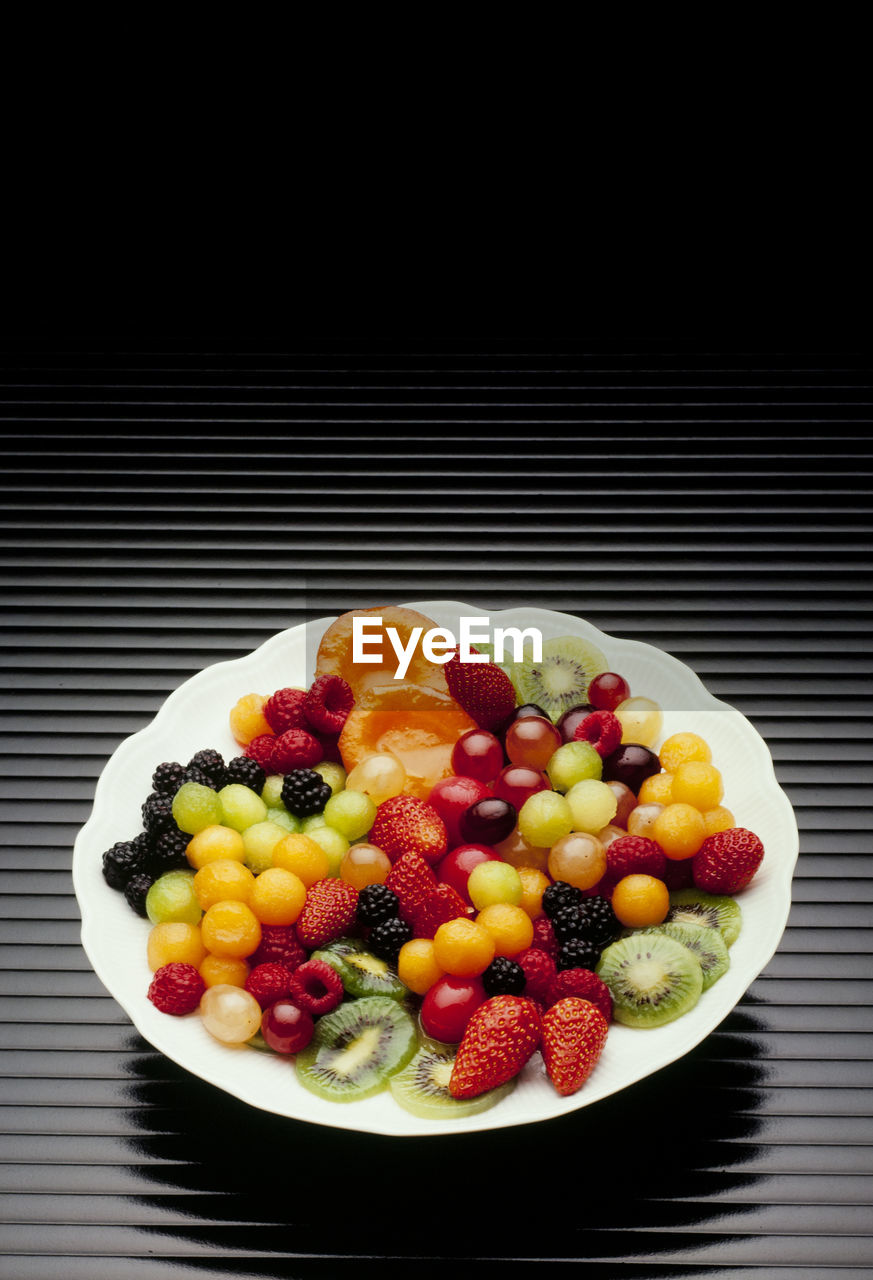 High angle view of colorful fruits in plate on table