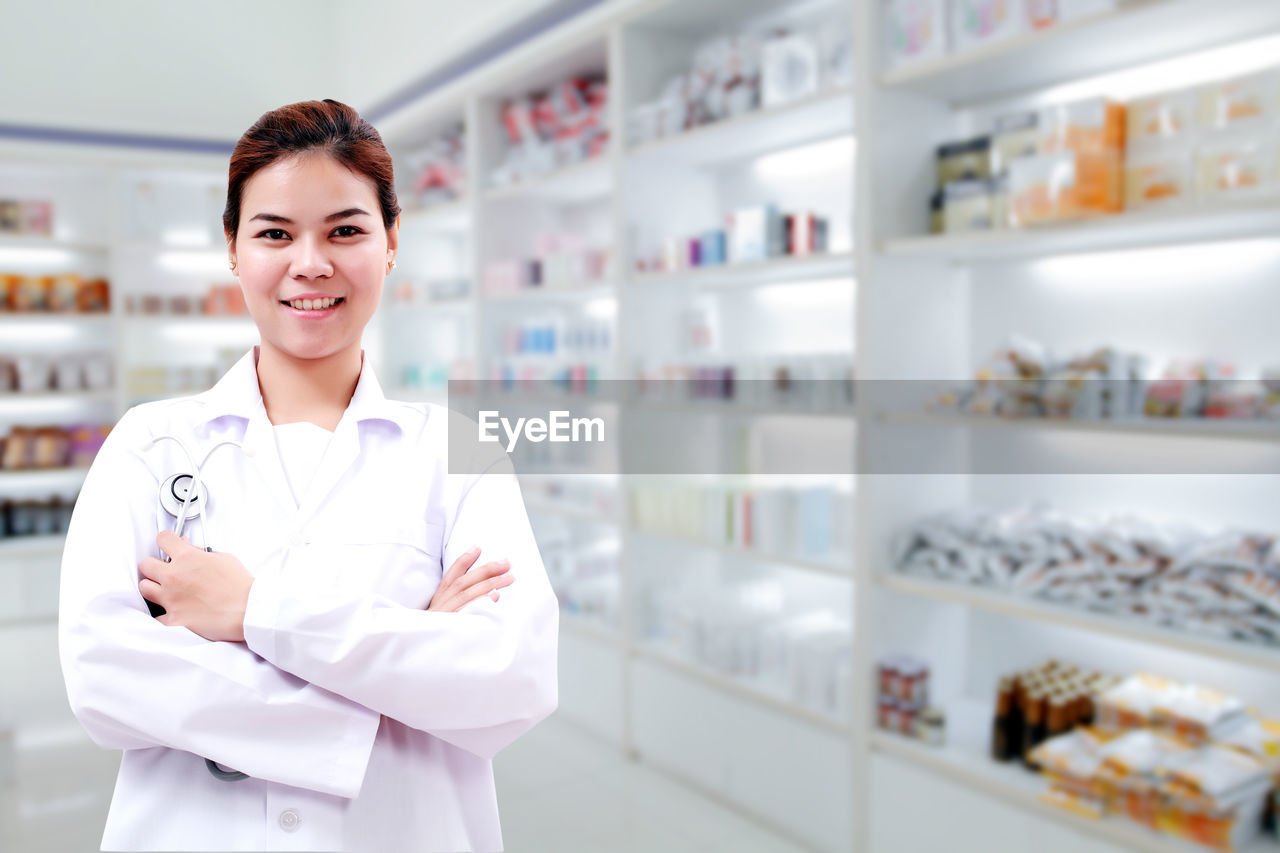 Portrait of smiling doctor standing in storage room at hospital 