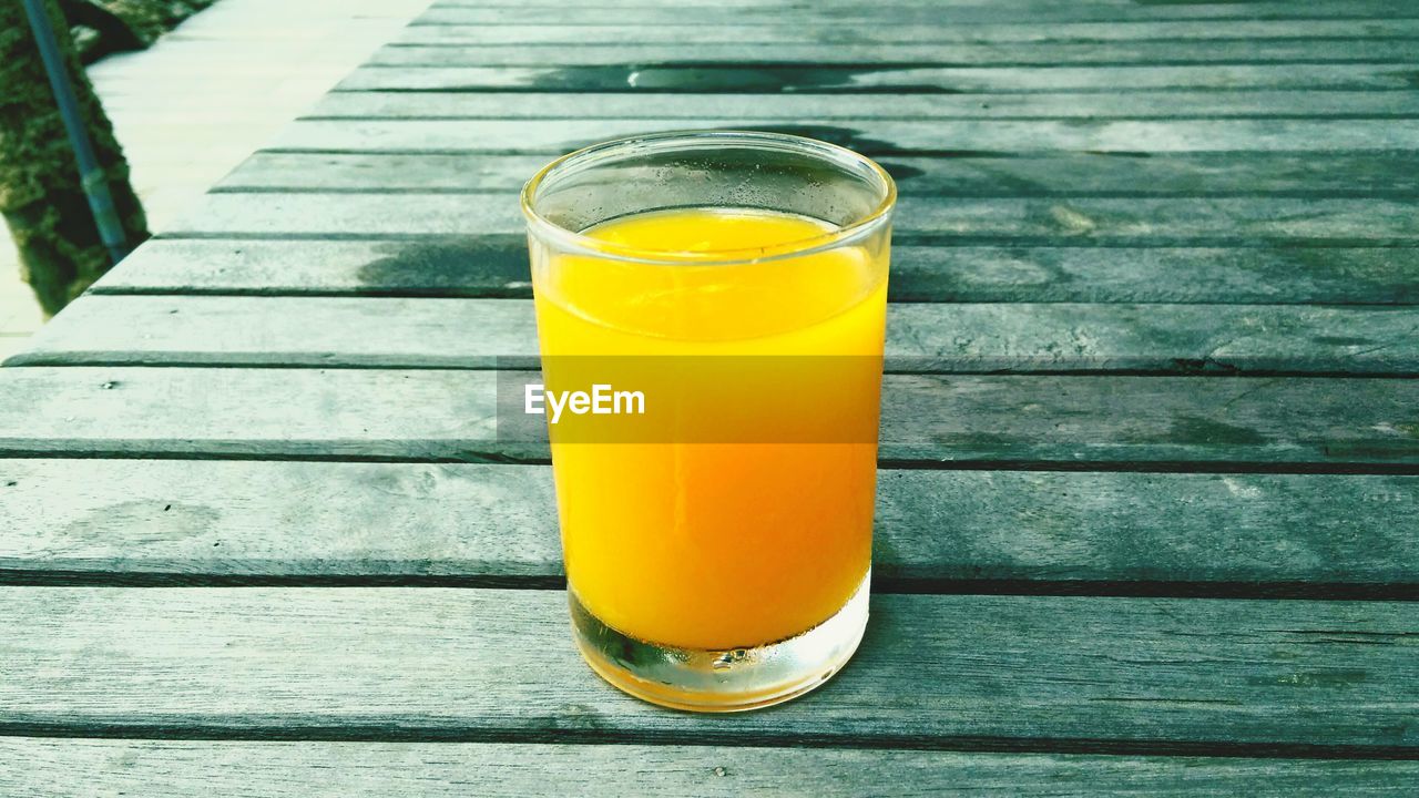 Close-up of orange juice in glass on table