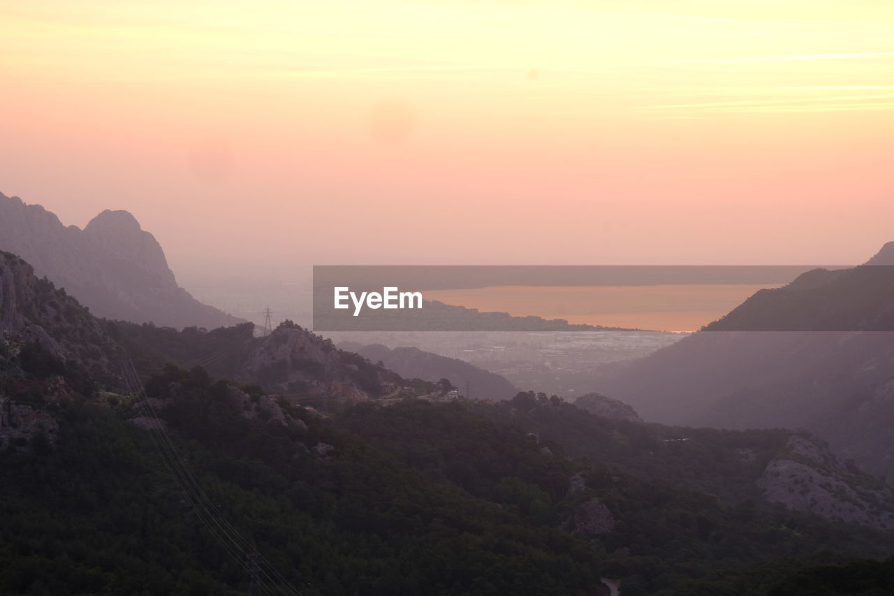 SCENIC VIEW OF MOUNTAINS DURING SUNSET