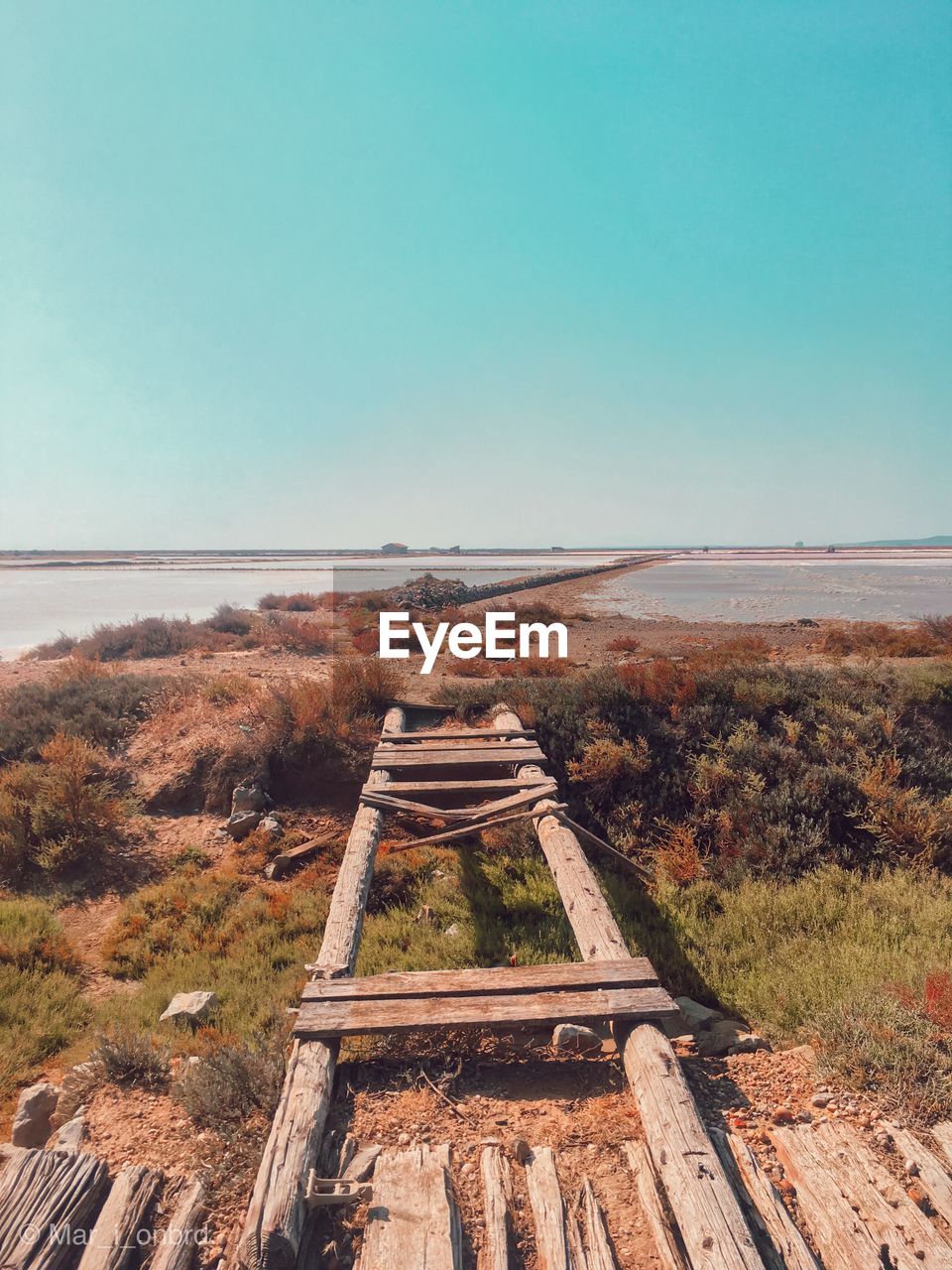 Scenic view of old landscape against clear blue sky