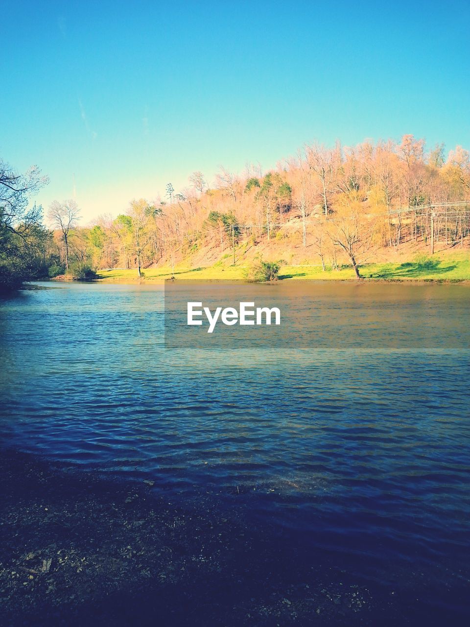 SCENIC VIEW OF LAKE AGAINST BLUE SKY