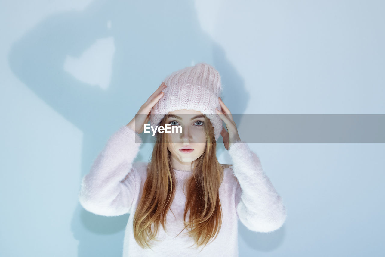 Young woman in sweater and hat