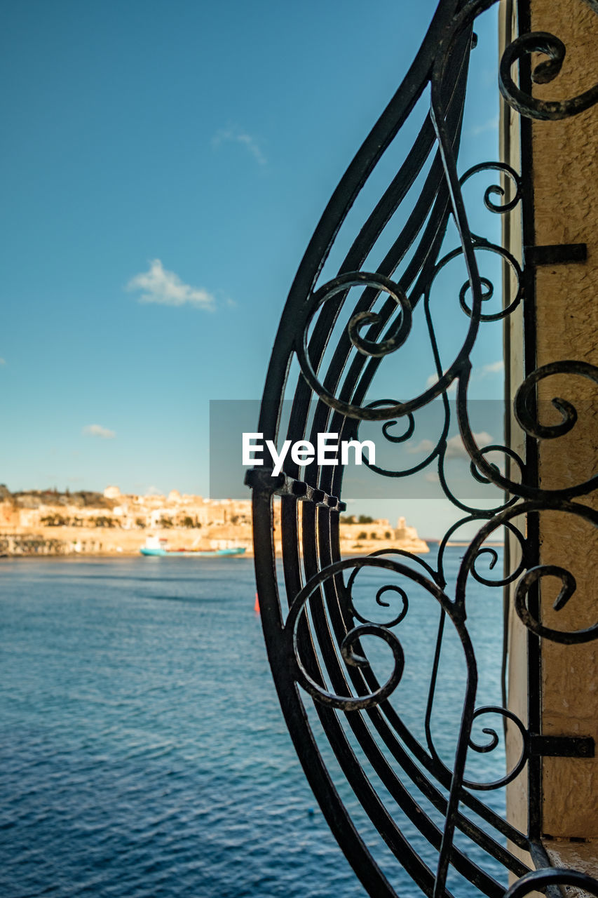 sky, water, architecture, nature, built structure, cloud, sea, railing, no people, blue, building exterior, iron, reflection, day, outdoors, city, building, metal, wrought iron, travel destinations, spiral, scenics - nature, beauty in nature, sunlight