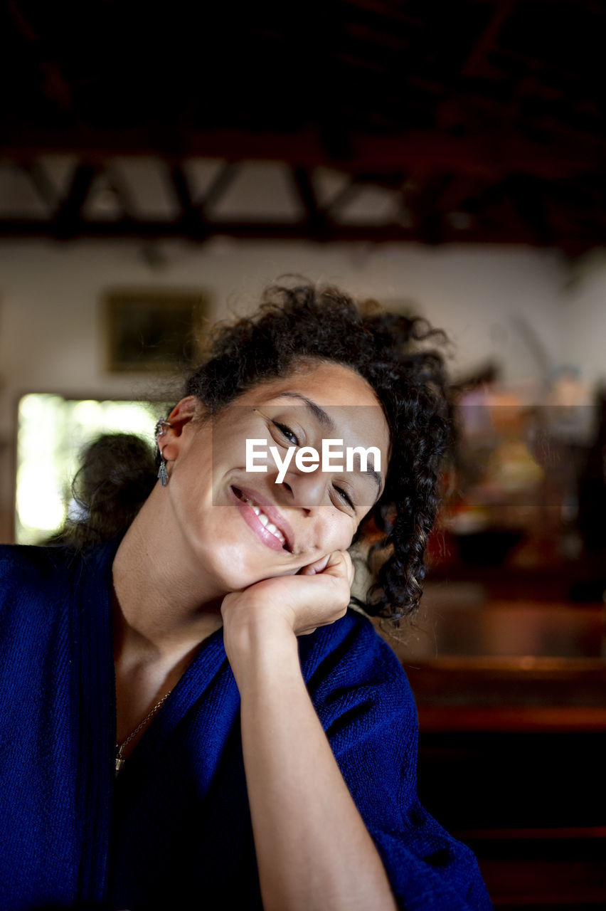 Mixed race woman looking at camera and smiling.