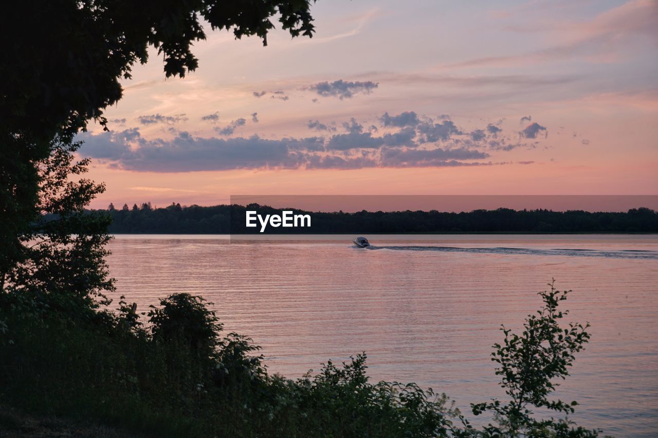 Scenic view of lake against sky during sunset