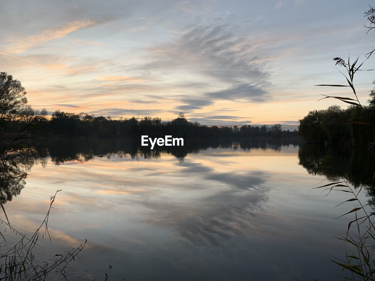 Scenic view of lake against sky during sunset