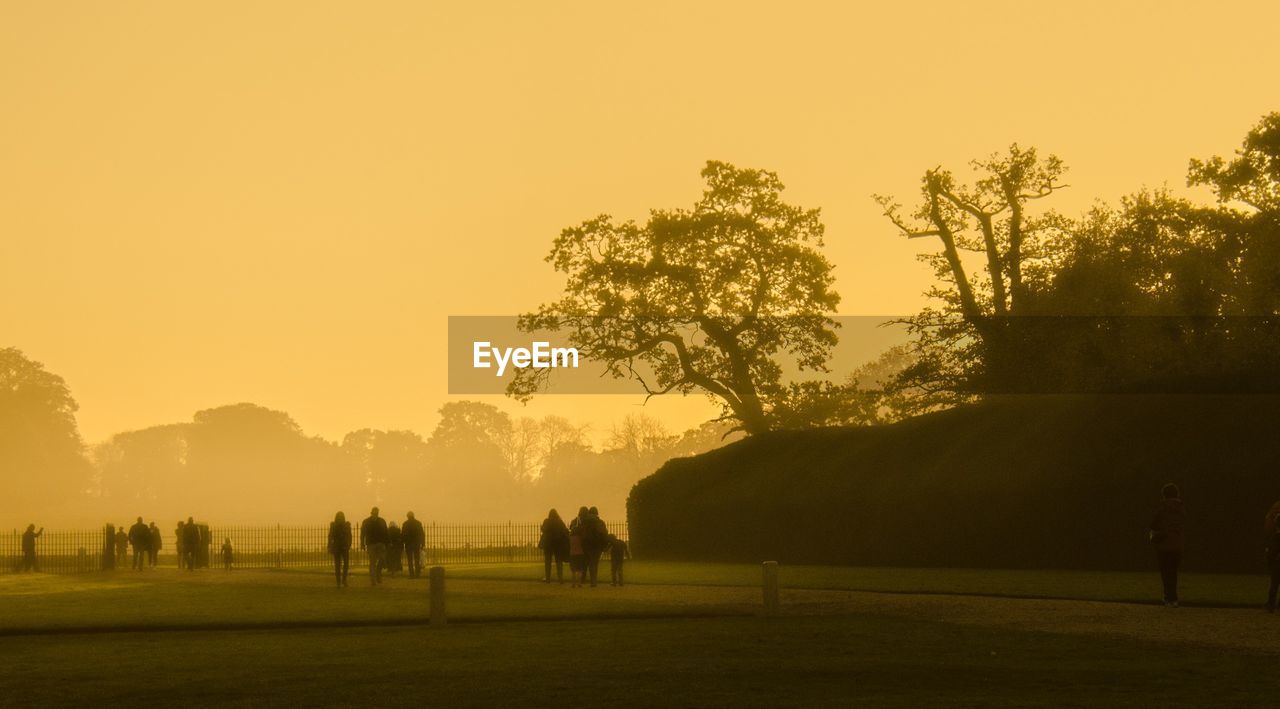 Group of silhouette people on countryside landscape